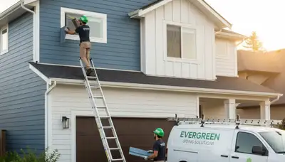 Technician repairing cracked vinyl siding on Las Vegas NV home exterior